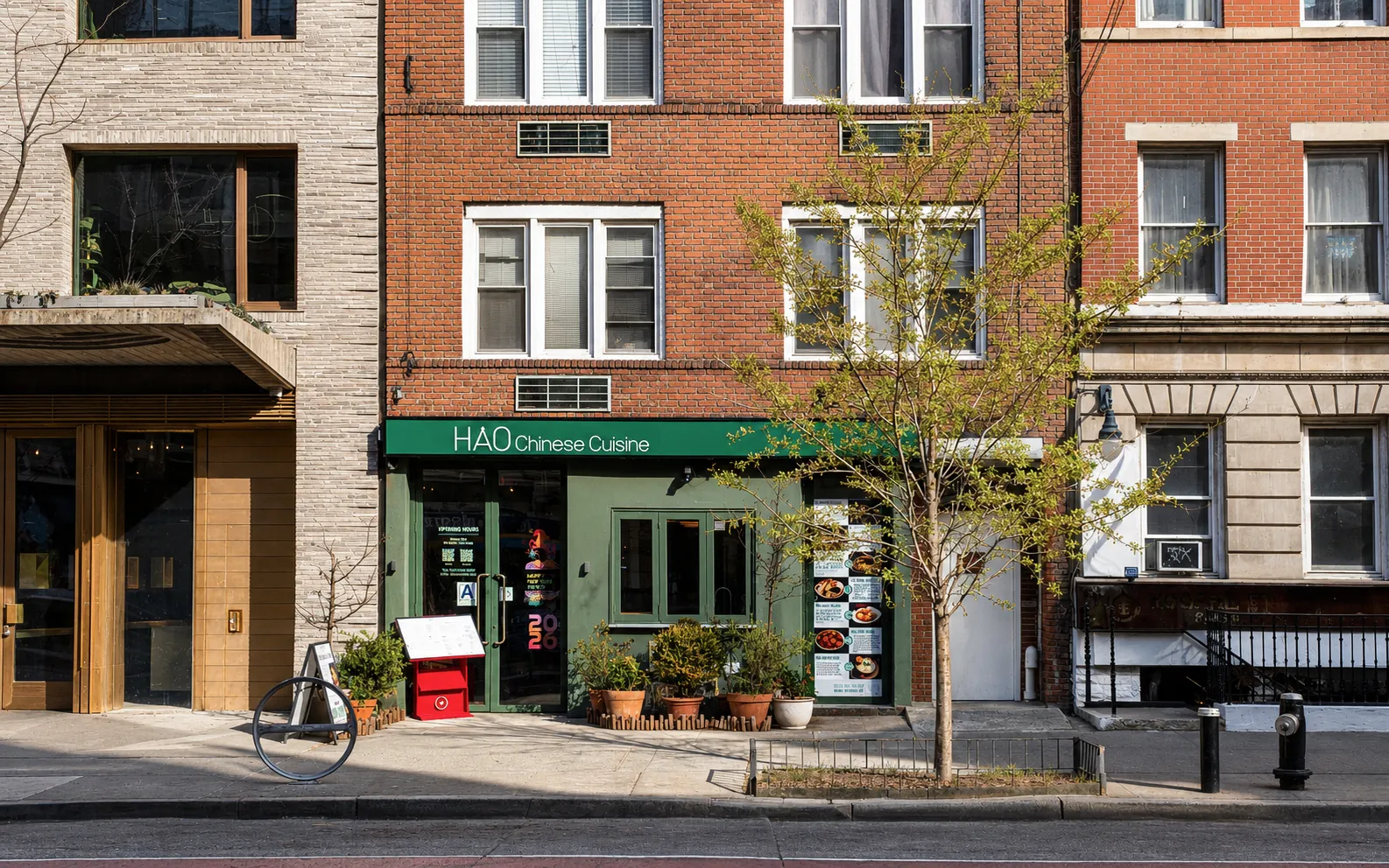 Green storefront of a noodle restaurant in a red-brick building on a Chelsea street in New York