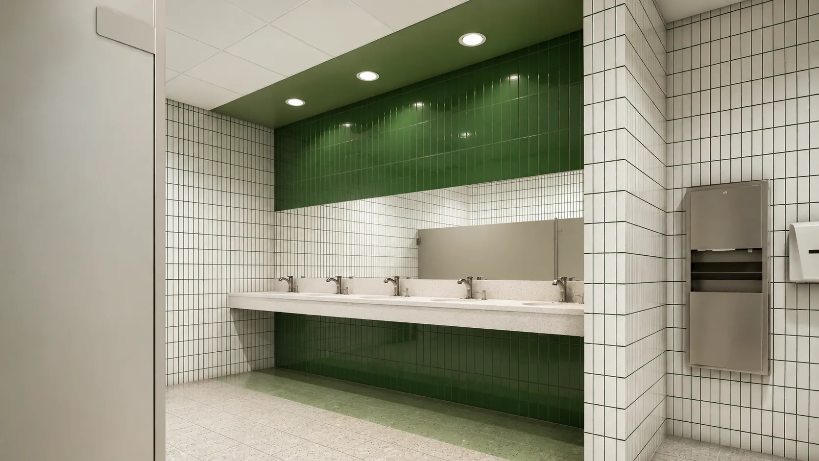 School restroom with white and green tile and a terrazzo trough sink counter in a Bronx, New York K-12 school