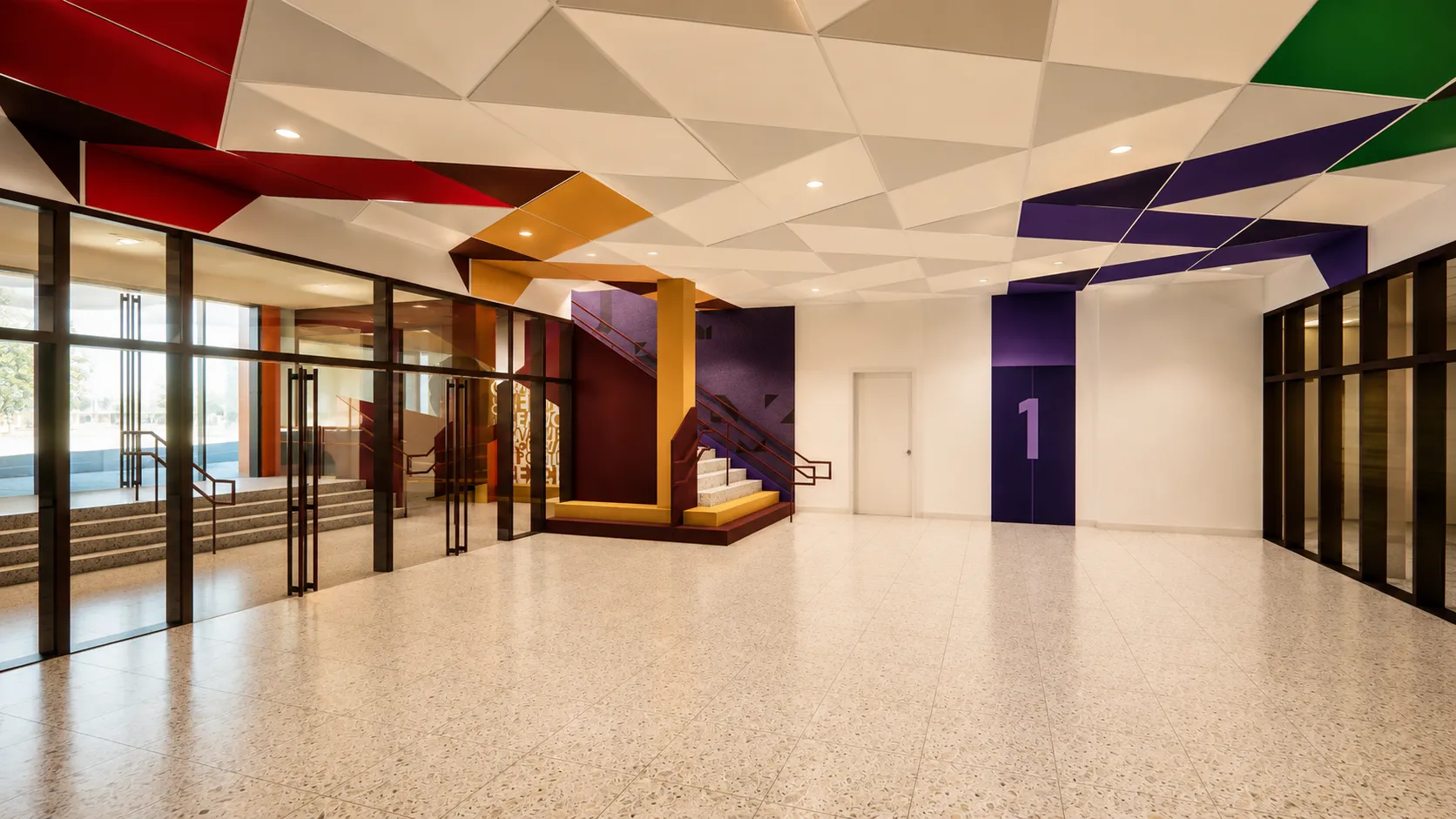 School lobby with a multicolor angular ceiling, terrazzo floor, and a mural portrait in a Bronx, New York K-12 school